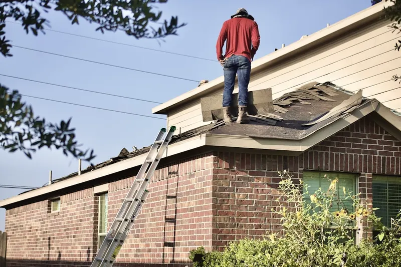 Professional roofer working on a residential roof in Flovilla